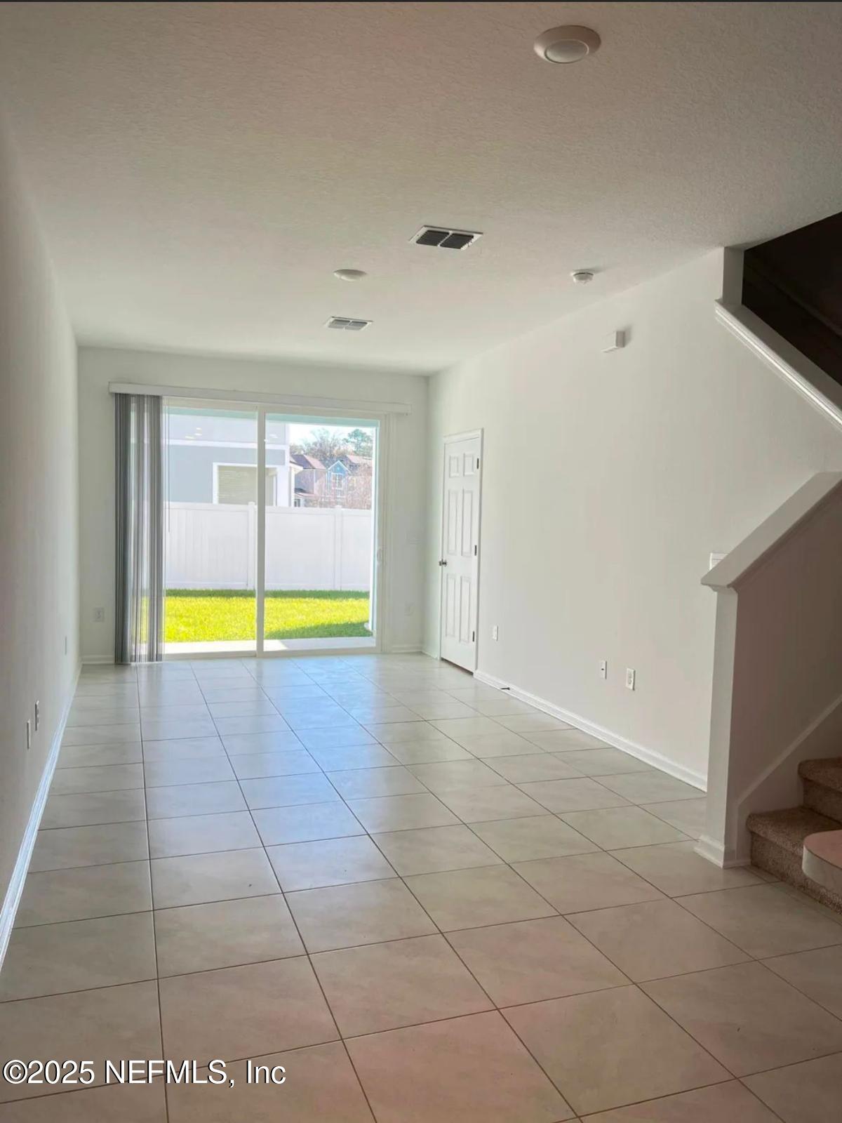 8368 Retrograde Road Jacksonville, FL 32256 - Photo 6 of 16 a view of an empty room with a fireplace