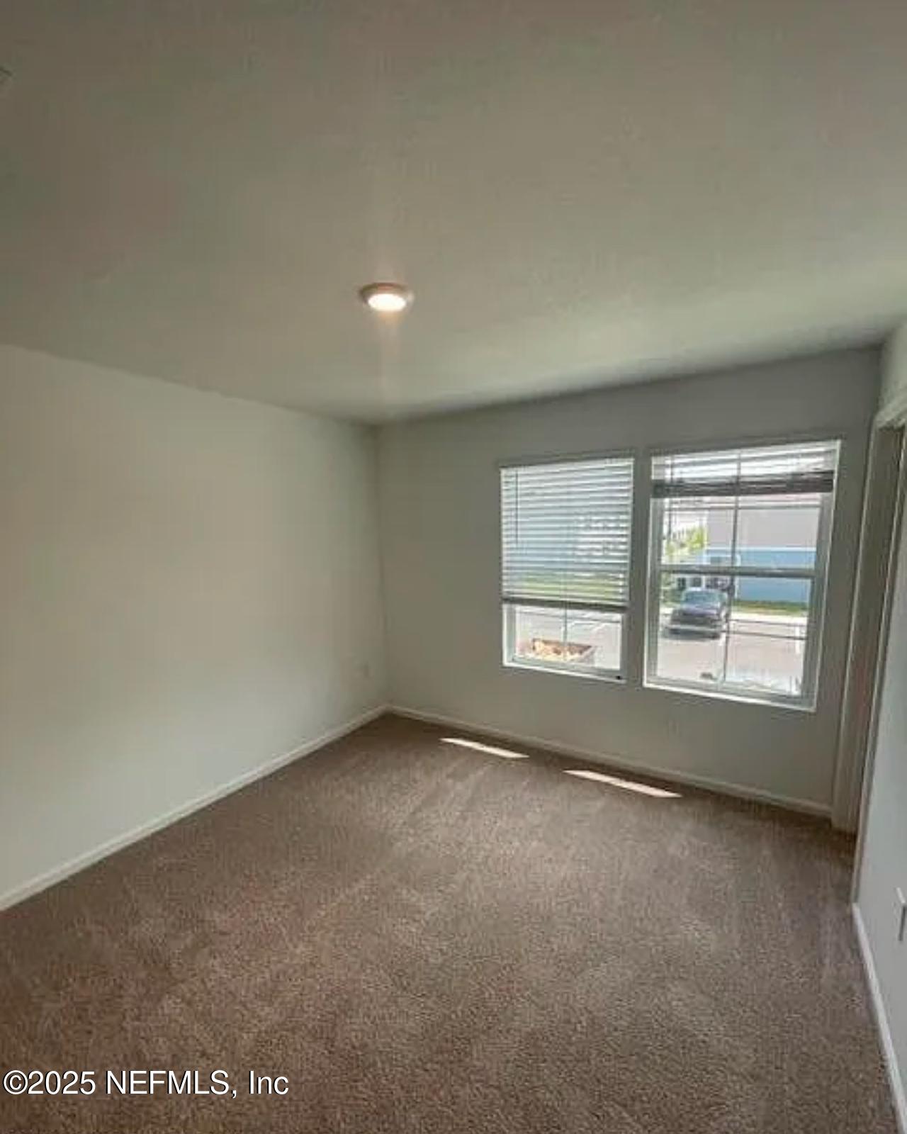 8368 Retrograde Road Jacksonville, FL 32256 - Photo 9 of 16 an empty room with a window