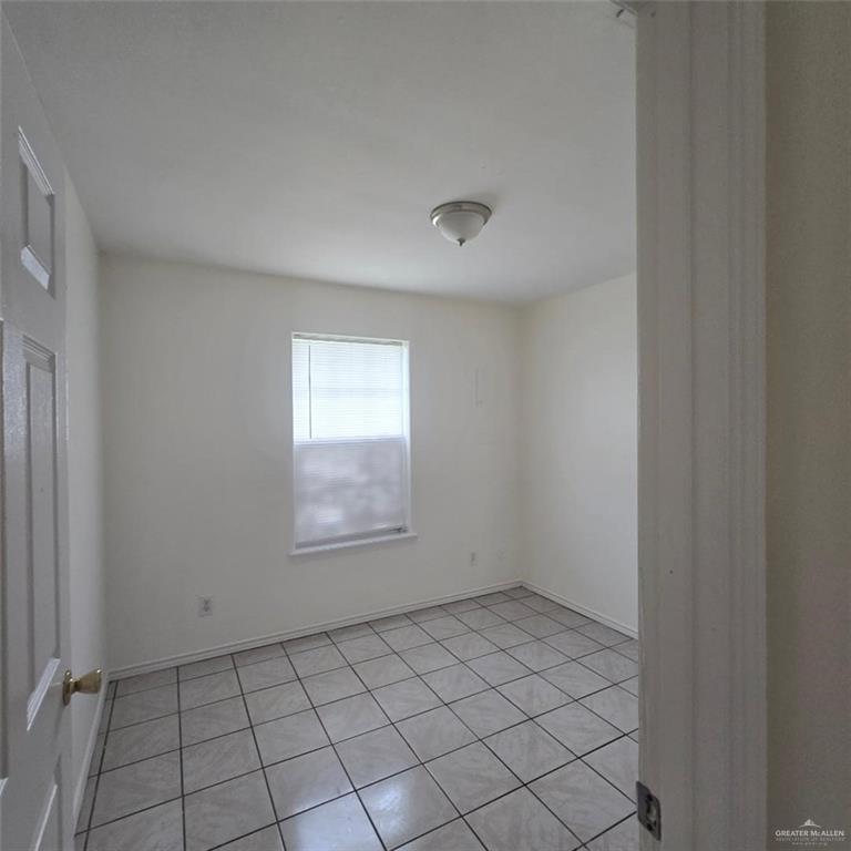 3915 South Alamo Road, Unit 10 Edinburg, TX 78542 - Photo 4 of 9 Empty room with light tile patterned flooring