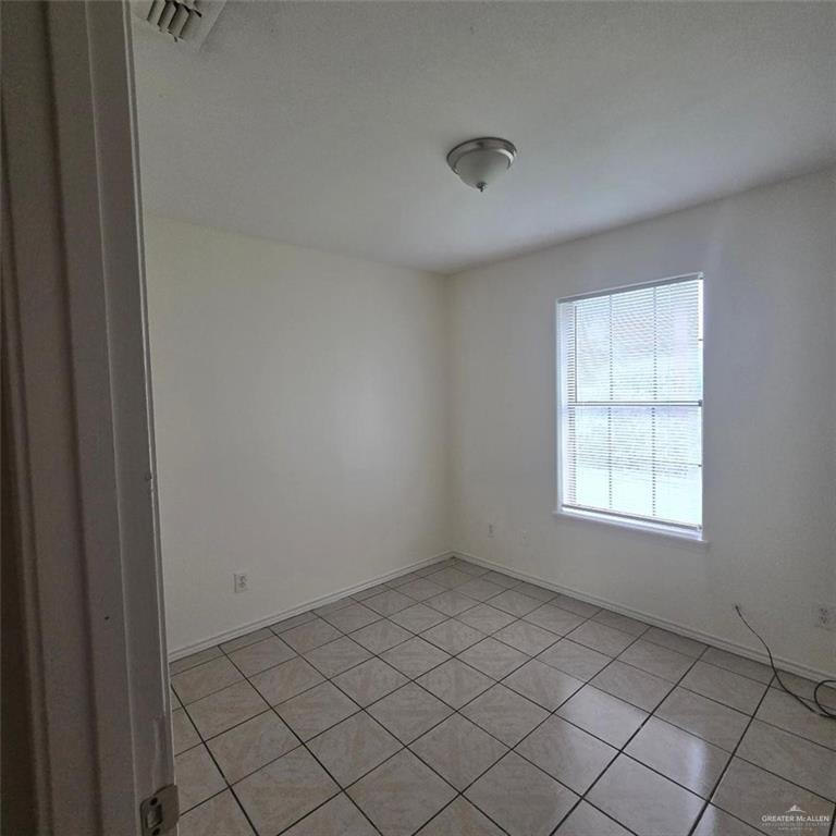 3915 South Alamo Road, Unit 10 Edinburg, TX 78542 - Photo 5 of 9 Spare room with light tile patterned floors