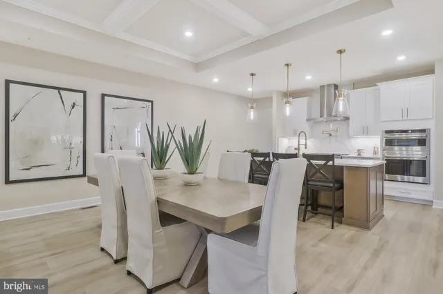 a dining room with furniture and wooden floor