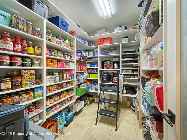 a kitchen with stainless steel appliances granite countertop a sink refrigerator and cabinets