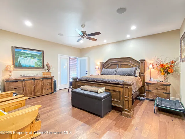 a dining room with furniture potted plants and wooden floor