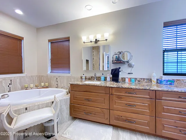 a living room with furniture a flat screen tv and a window
