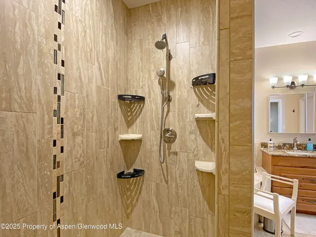 a bedroom with furniture and a large window