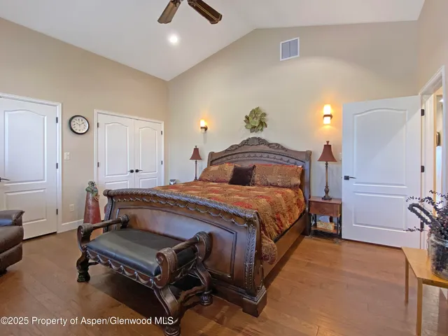 a bathroom with a granite countertop sink a large mirror and a bathtub