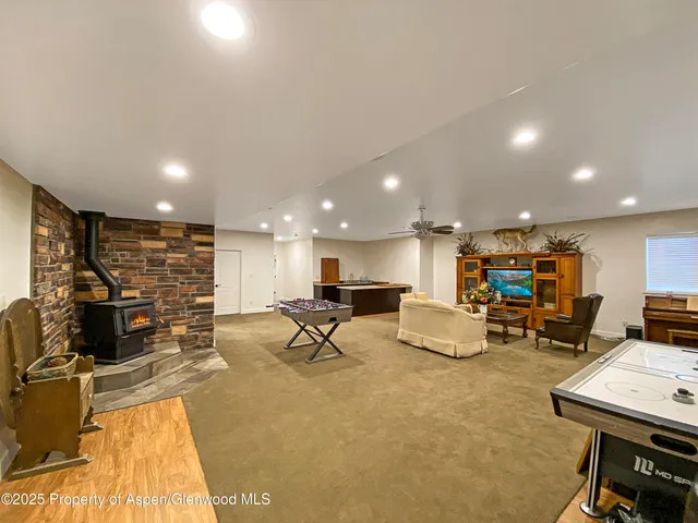 a bathroom with a granite countertop sink a mirror and shower