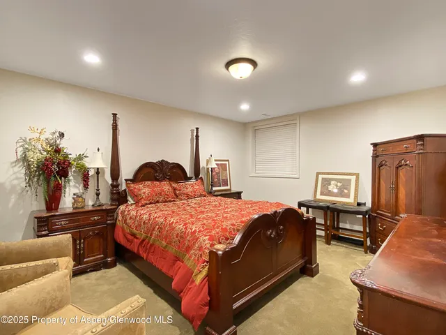 a living room with furniture a rug and white walls
