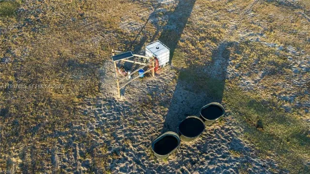 a view of a field with trees in the background