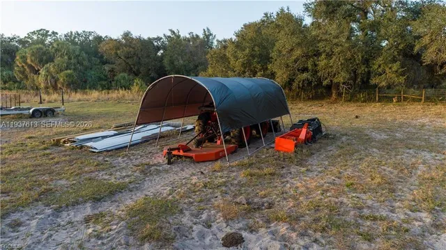 a backyard of a house with table and chairs
