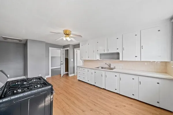 a kitchen with granite countertop a stove and a sink