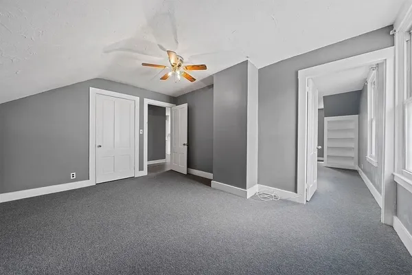 a view of empty room with ceiling fan