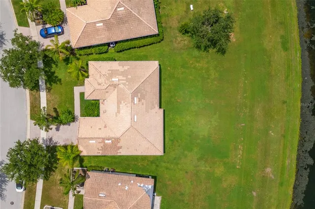an aerial view of a house with a yard