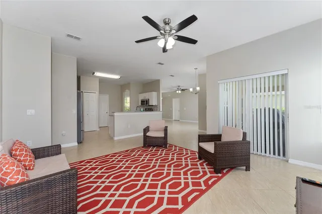a bedroom with furniture and a large window