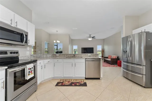 a kitchen with a sink cabinets and stainless steel appliances