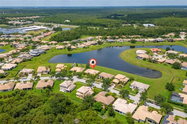 an aerial view of ocean and residential houses with outdoor space