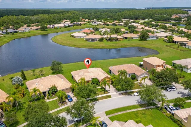 an aerial view of a house with a lake view