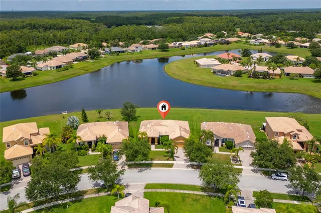 an aerial view of a house with a swimming pool yard and outdoor seating