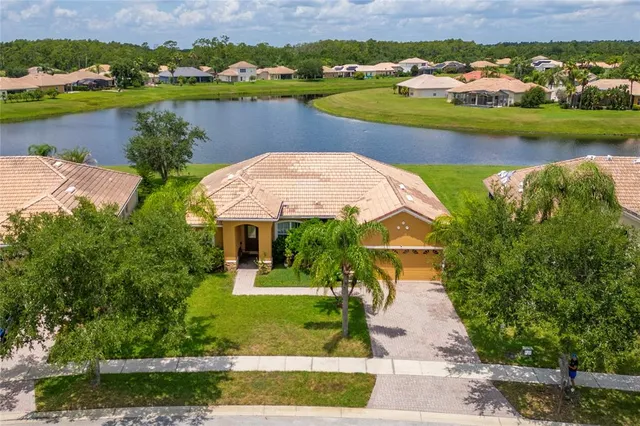 an aerial view of a house with a lake view