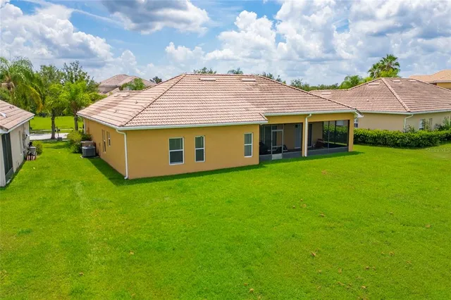 a aerial view of a house with a yard table and chairs