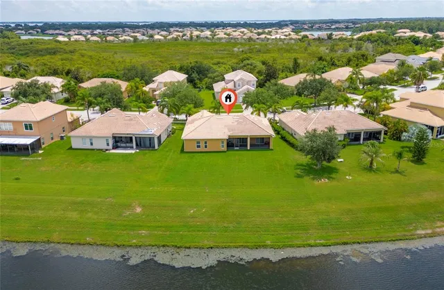 an aerial view of a houses with outdoor space swimming pool and mountains