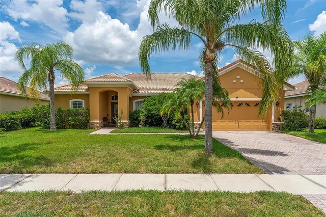 a front view of a house with a garden and yard