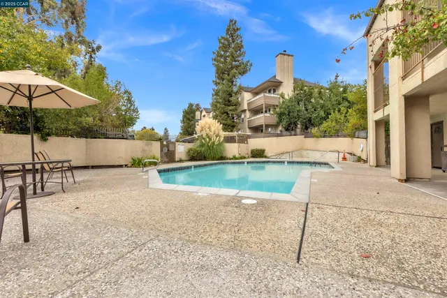 a view of a house with backyard and sitting area