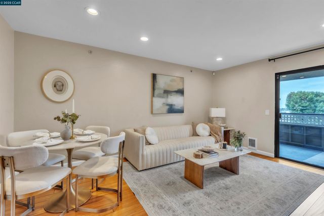 a living room with furniture a window and a clock