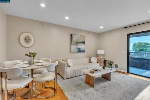 a living room with furniture a window and a clock