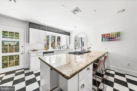 a kitchen with stainless steel appliances granite countertop a sink and cabinets