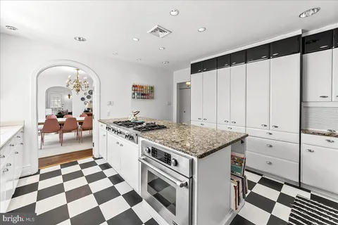 a kitchen with a stove a sink and a refrigerator