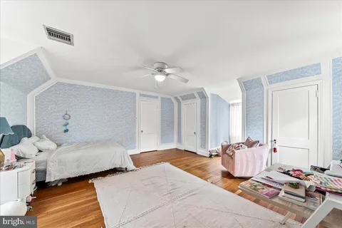 a bedroom with two beds and a chandelier