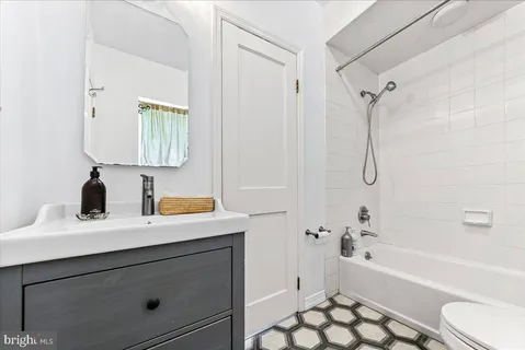 a bathroom with a sink a toilet and a bathtub