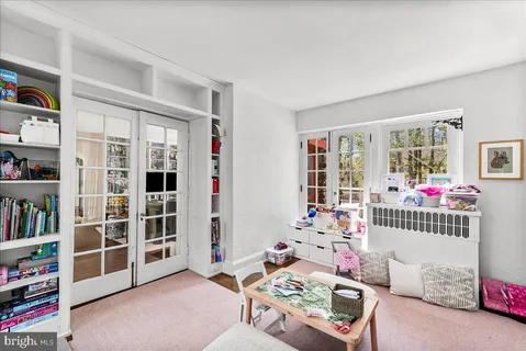 a bedroom with furniture and a book shelf