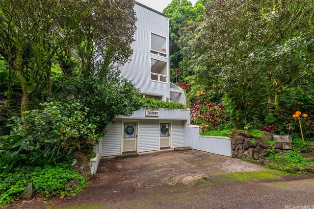 a view of a house with a tree and plants