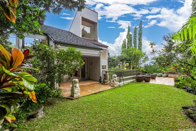 a view of a house with a yard porch and sitting area