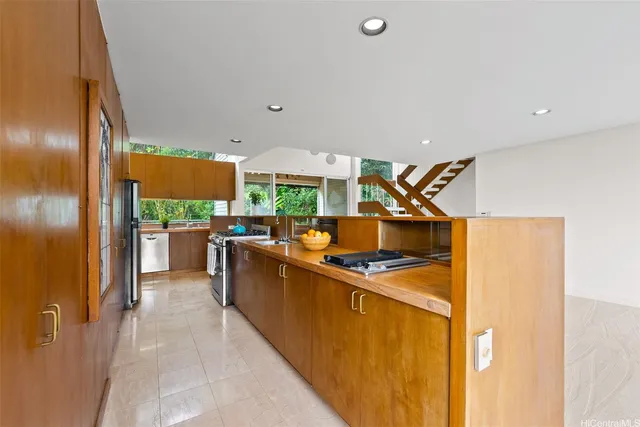 a kitchen with stainless steel appliances granite countertop a stove a sink and a refrigerator