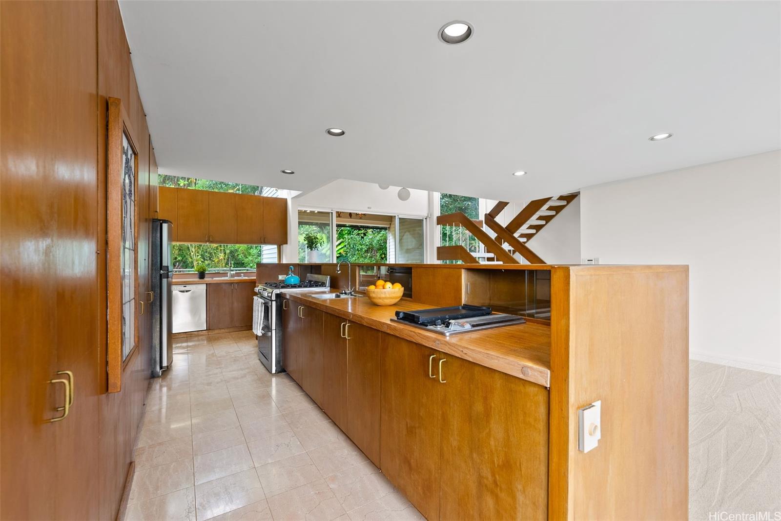 156 Forest Ridge Way Honolulu, HI 96822 - Photo 8 of 25 a kitchen with stainless steel appliances granite countertop a stove a sink and a refrigerator