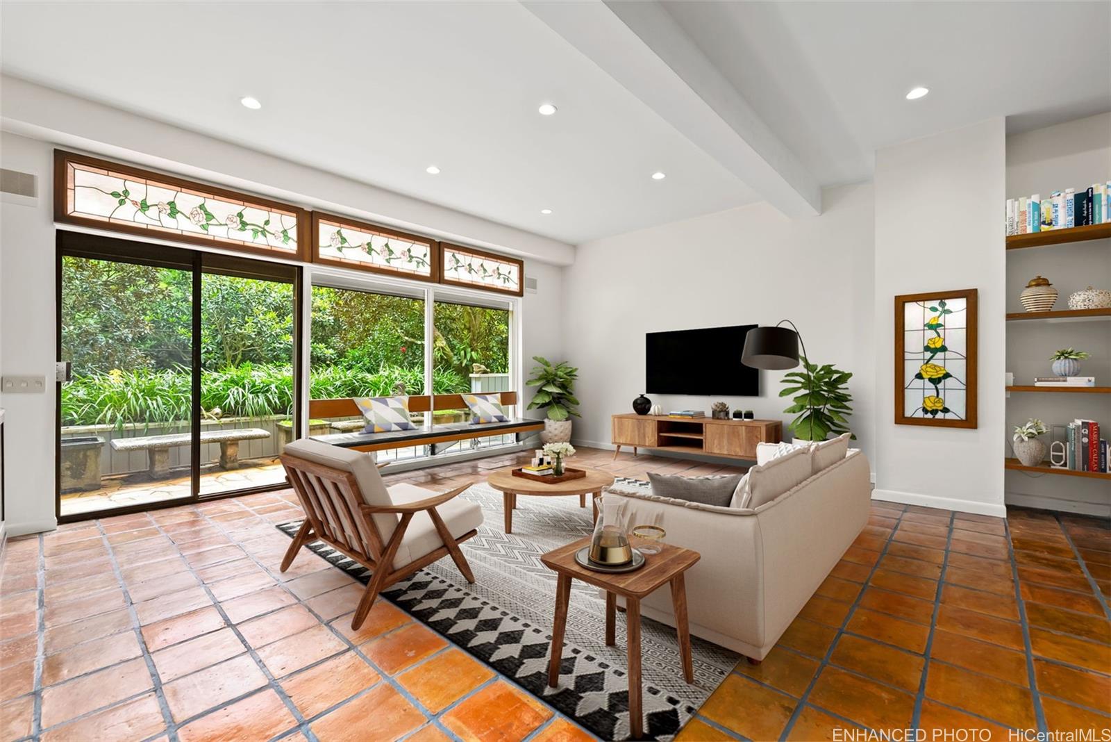 156 Forest Ridge Way Honolulu, HI 96822 - Photo 9 of 25 a living room with furniture floor to ceiling window and a flat screen tv