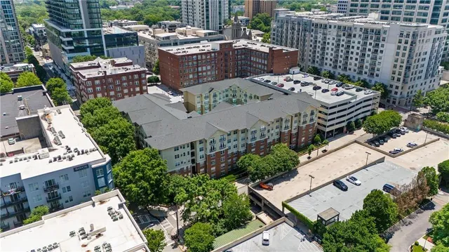 a view of a patio with a table and chairs and a barbeque