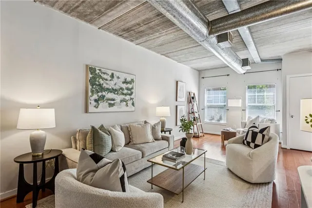 a living room with furniture and a lamp