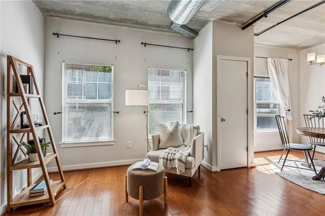 a living room with furniture and a wooden floor