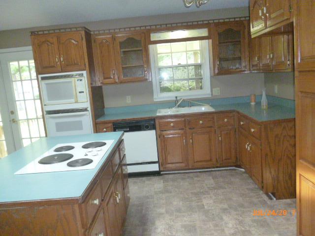 610 Beaverdam Road Camden, TN 38320 - Photo 8 of 15 a kitchen with a sink stove and cabinets