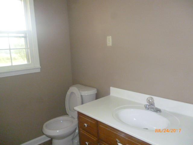 610 Beaverdam Road Camden, TN 38320 - Photo 10 of 15 a bathroom with a toilet sink and mirror