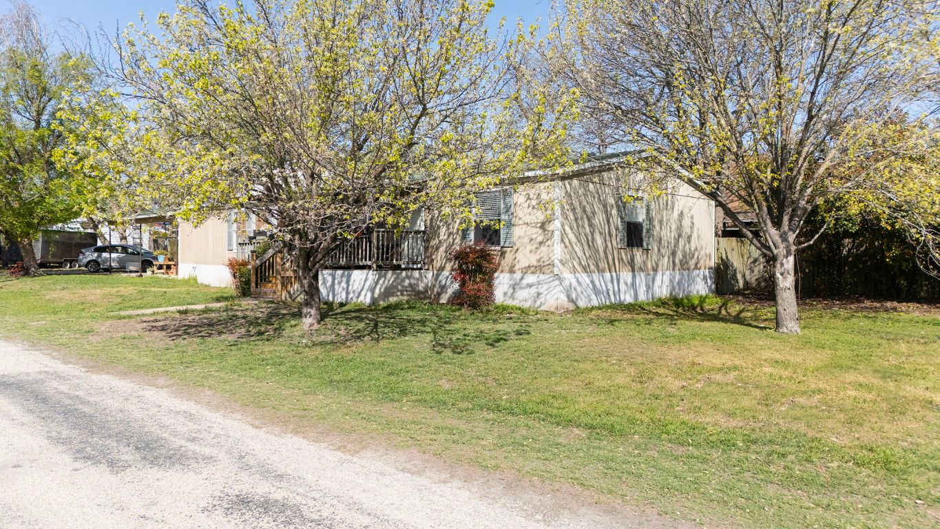 209 East Sheldon Avenue Thrall, TX 76578 - Photo 20 of 20 a backyard of a house with fountain table and chairs