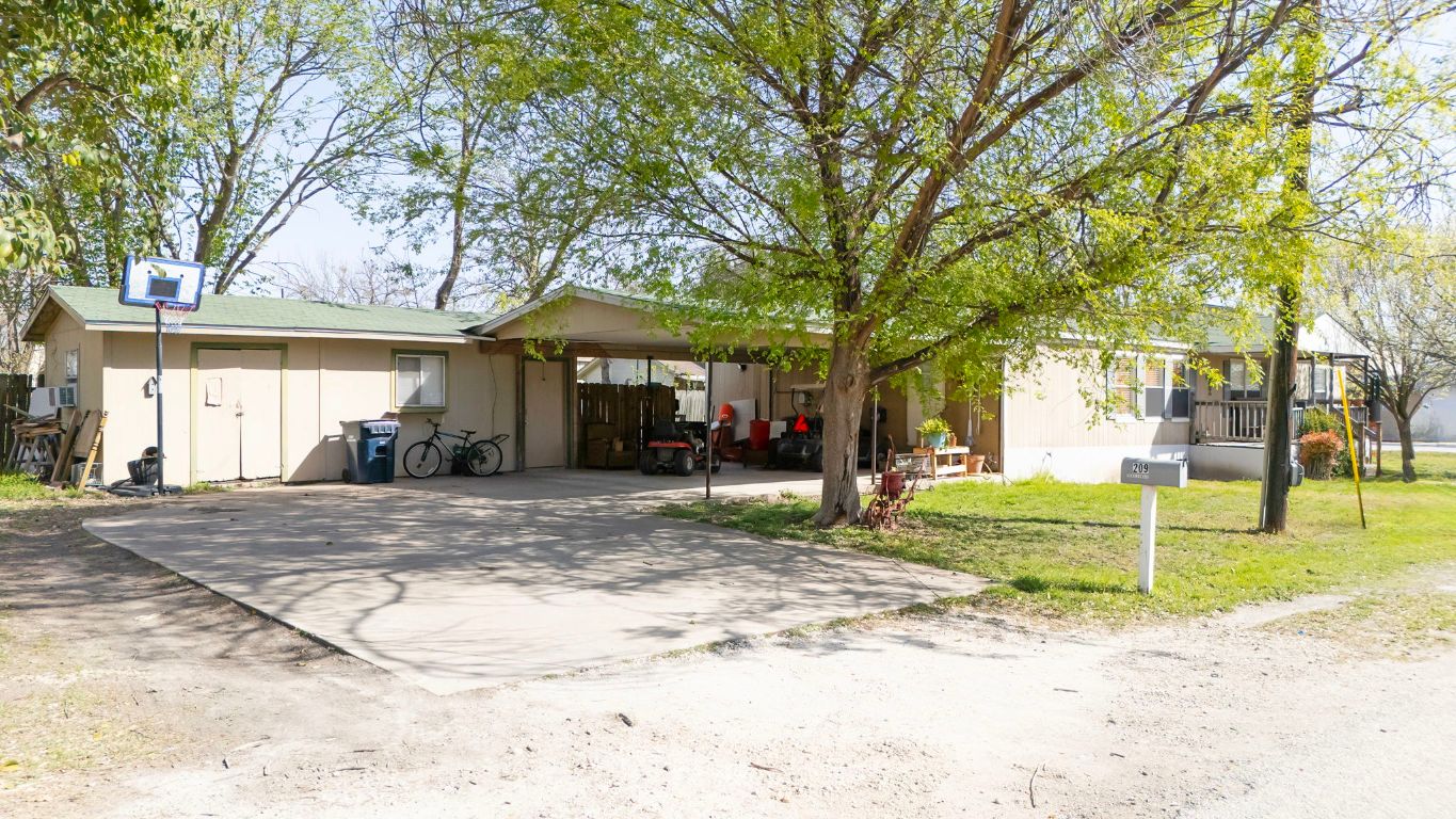 209 East Sheldon Avenue Thrall, TX 76578 - Photo 2 of 20 a view of a trees in front of a house
