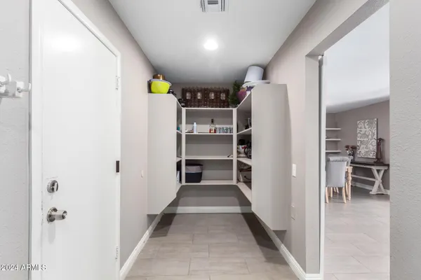a view of kitchen with furniture and refrigerator