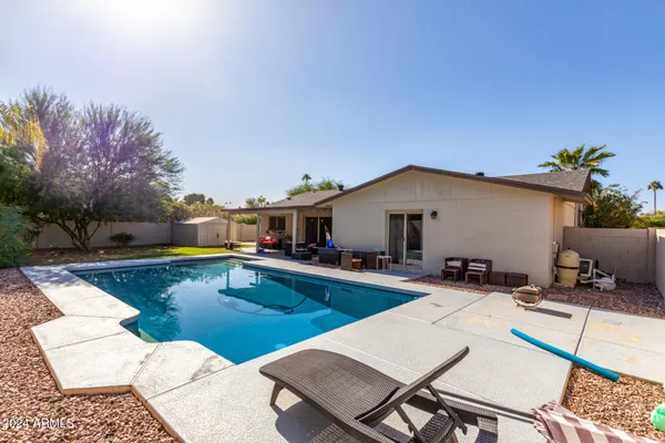 a view of a house with swimming pool in front of it