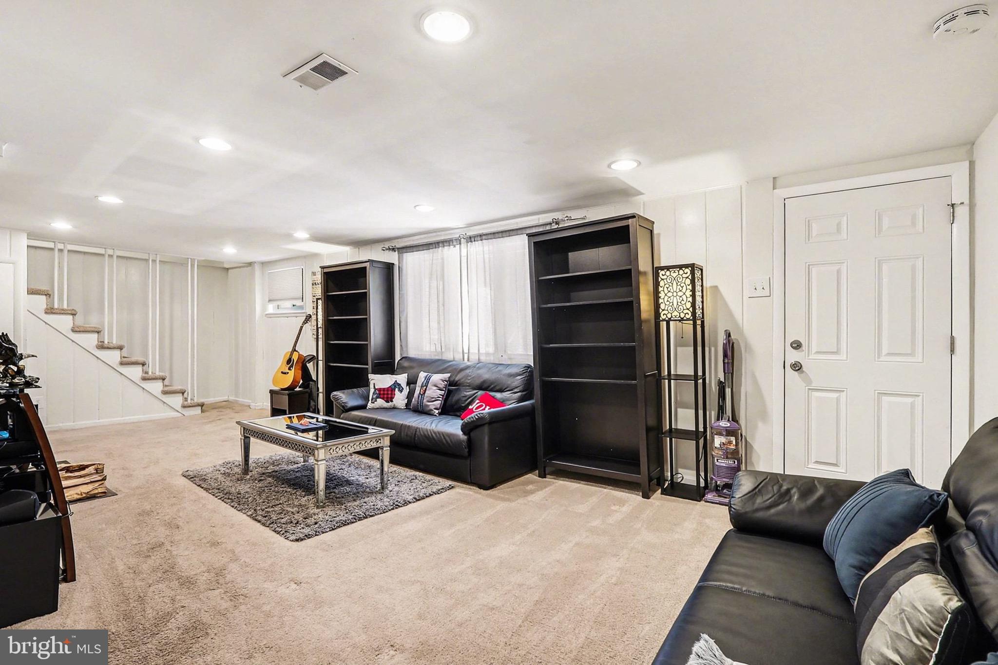 7112 Dalhouse Street Springfield, VA 22151 - Photo 17 of 25 a living room with furniture and a flat screen tv