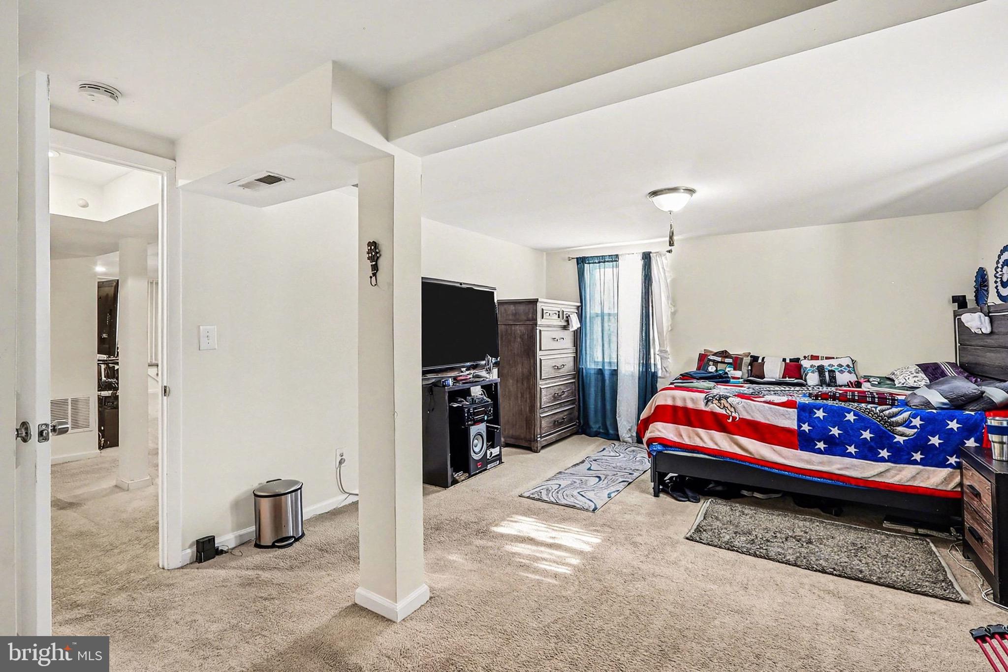 7112 Dalhouse Street Springfield, VA 22151 - Photo 18 of 25 a bedroom with bed and a chandelier